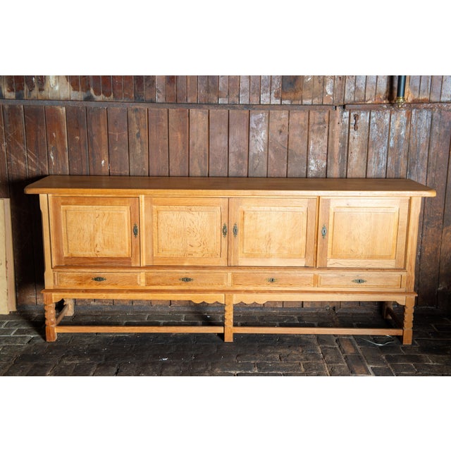 This solid white oak quarter sawn Danish sideboard is attributed to Henning Kjaernulf. This sideboard features four...