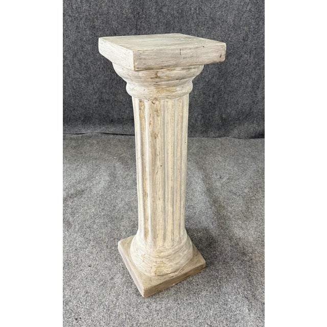 This gray Roman column pedestal features a classic fluted design with a square base and top, evoking timeless...