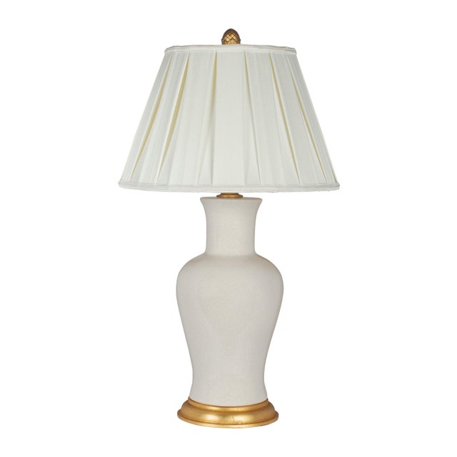 Dramatic curves define the silhouette of this impressive white ceramic table lamp. A light crackle finish adds wonderful...