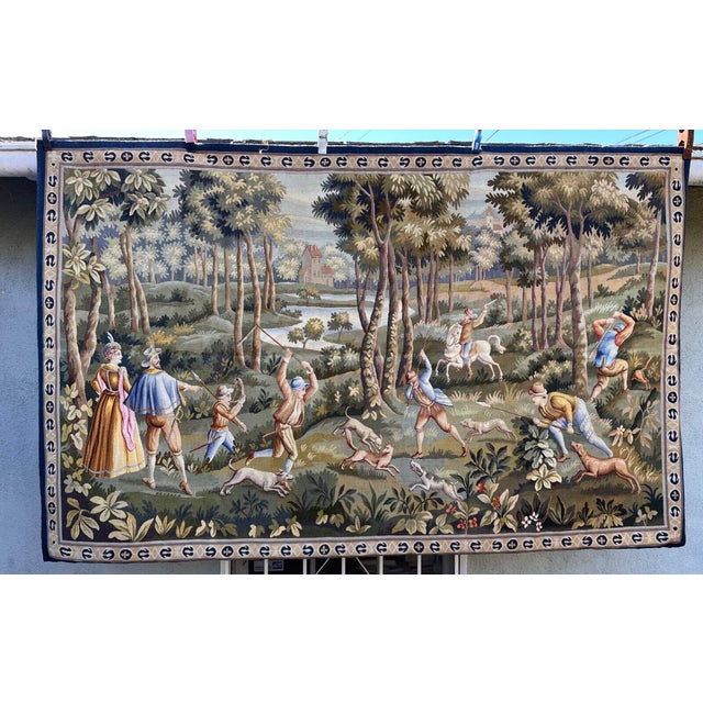 This is a beautiful tapestry depicting the hunt. The background is with trees, river and castle.