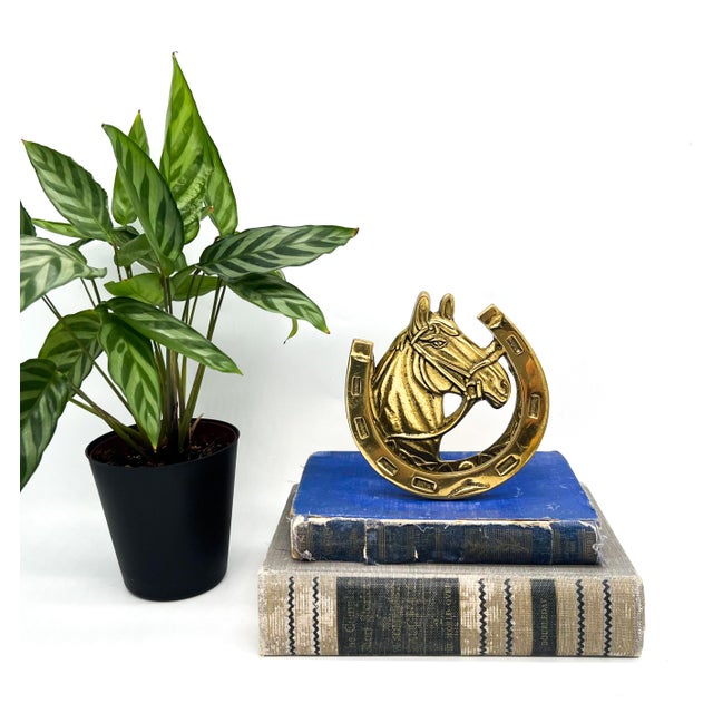 Brilliant, solid brass door knocker featuring a dimensional bridled horse head framed by a hinged horseshoe. The...