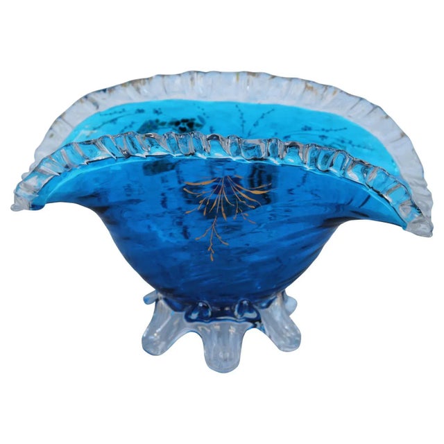 Fan shaped blue enameled glass decorated with Japanese inspired ribbons and flowers. Work was done by glassmaker Auguste...