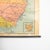 A vintage school pull down wall map of australia. The map has a wooden hanging pole at the top and bottom. The map is...