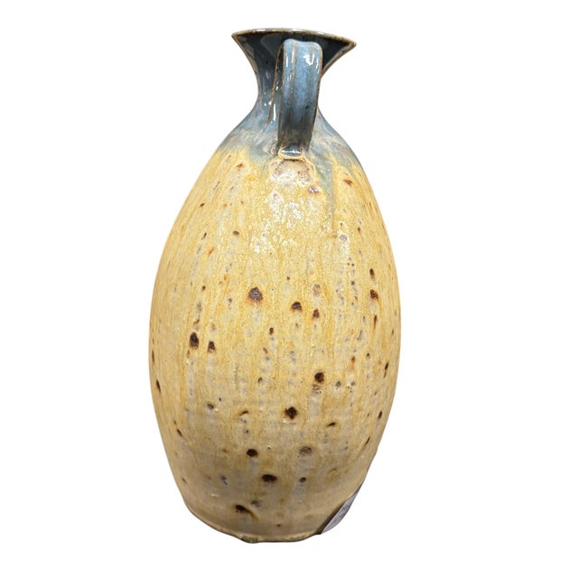 Handcrafted Seagrove Pottery vase featuring a beautiful blend of warm yellow glazes accented by a rich blue rim and...