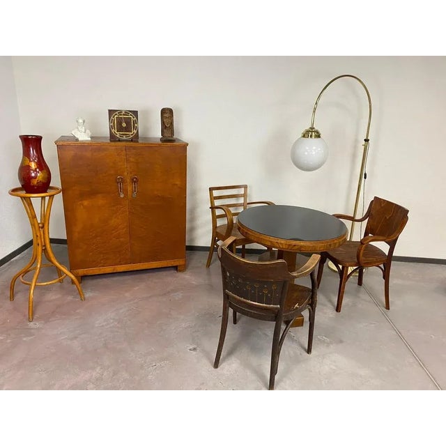 Art deco card table with black glass top in excellent condition. Original plate was damaged therefore was replaced by...