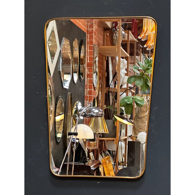 "A vintage Italian rectangular brass wall mirror from the 1980s, showcasing the classic elegance and craftsmanship of...