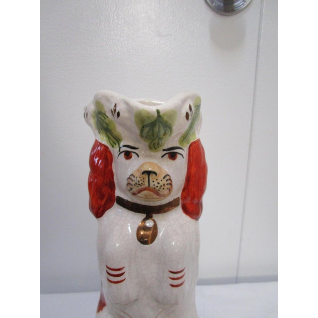 This Staffordshire Spaniel jug is impertinent, from his expression to his hopeful gaze. The eyes seem animated and almost...