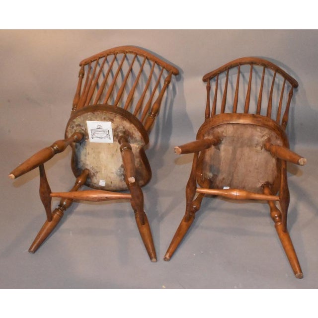 Companion pair of American Windsor fan back side chairs. Late 18th century. These early chairs are characterized by their...