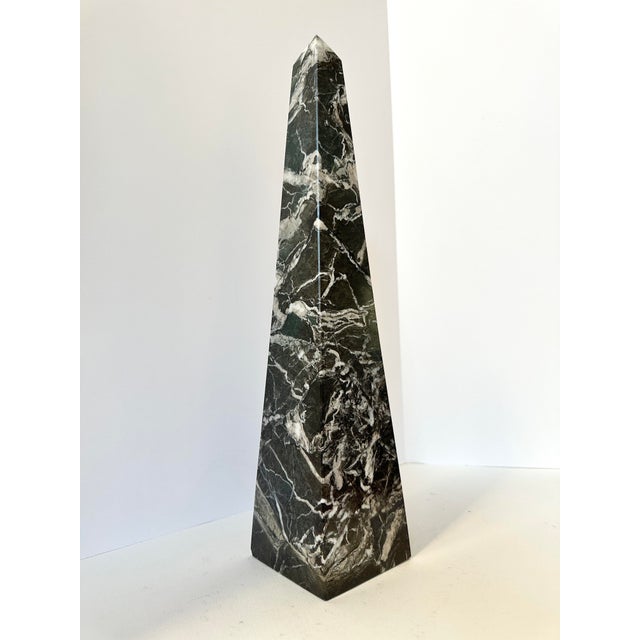 triking carved marble obelisk in dramatic black stone with bold white veining throughout. Crafted from solid marble and...
