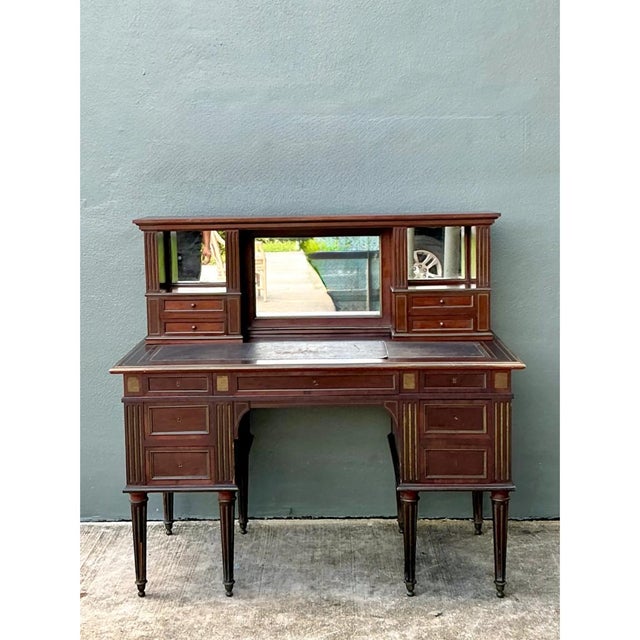 This vintage Louis XVI double pedestal writing desk is a magnificent example of classical French cabinetry, its imposing...