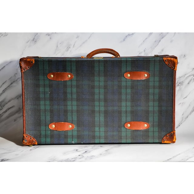 Returns A striking blend of classic heritage style and late 20th-century craftsmanship, this vintage tartan suitcase...