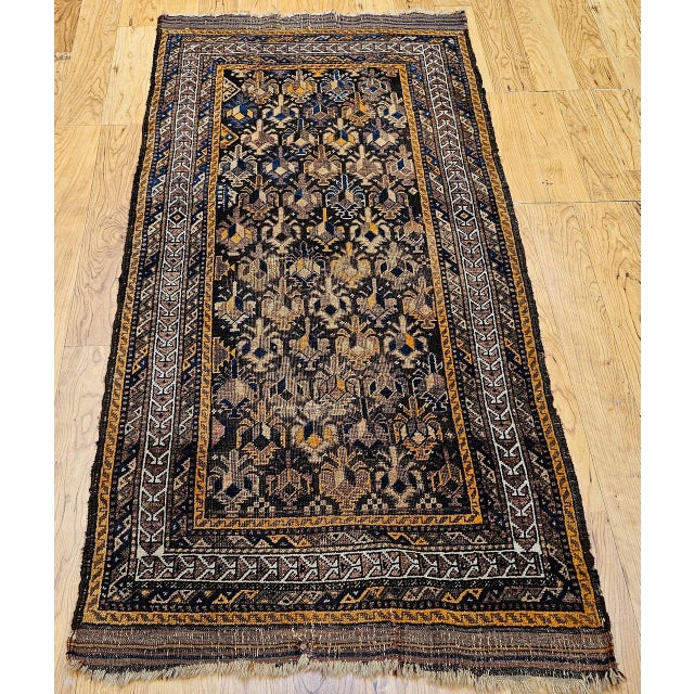 This exceptional vintage Baluch tribal rug from the late 1800s showcases an extraordinary allover geometric pattern with a...