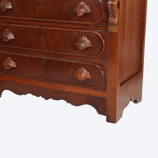 A finely crafted Renaissance Revival dresser from circa 1890, featuring intricately carved walnut wood and a marble top....