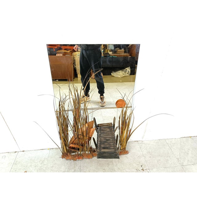 Striking vintage mirror sculpted by Belgian artist Daniel D'haeseleer. It depicts a sunset at a pond with a boat decorated...