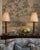 A tall pair of vintage table lamps featuring richly textured faux-bamboo column bases and warm, aged finishes. The slender...