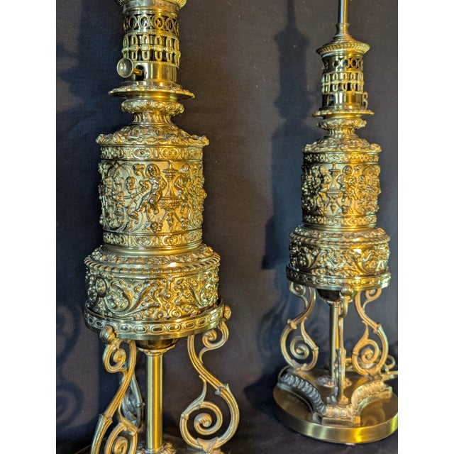 Pair of bronze repoussée oil lamps, French, mid-19th-century, wired for electricity. Newly rewired with quality clusters....
