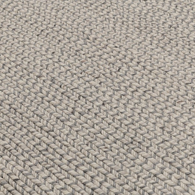 Wool polyester cozy rug in multiple tones of gray. Subtle herringbone patterning. Classic yet modern; perfect for a wide...