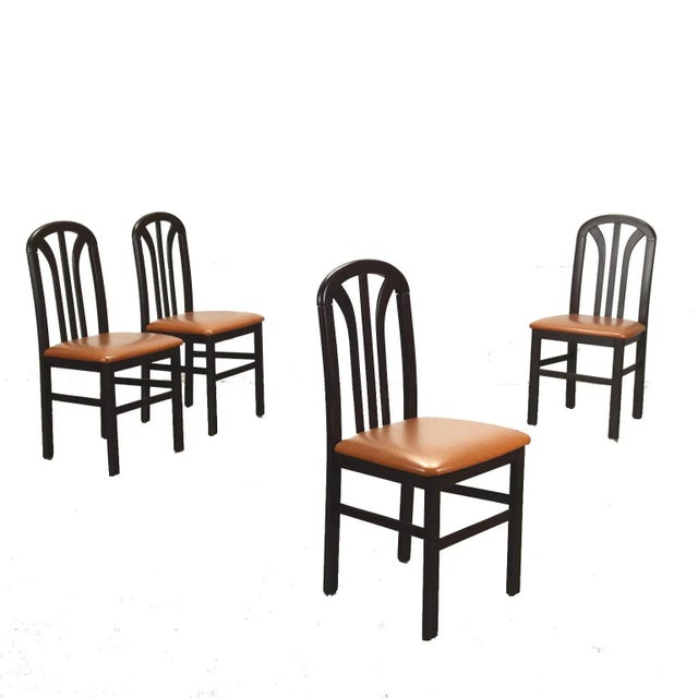 Group of 4 chairs in stained beech wood, foam padding, leatherette upholstery. This piece is attributed to the mentioned...