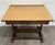 This is a vintage architect’s drafting table featuring a large adjustable work surface, brass angle-control hardware, an...