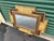 Decorative wall mirror made circa 1970s in the Hollywood Regency style, featuring a layered geometric frame with faux...