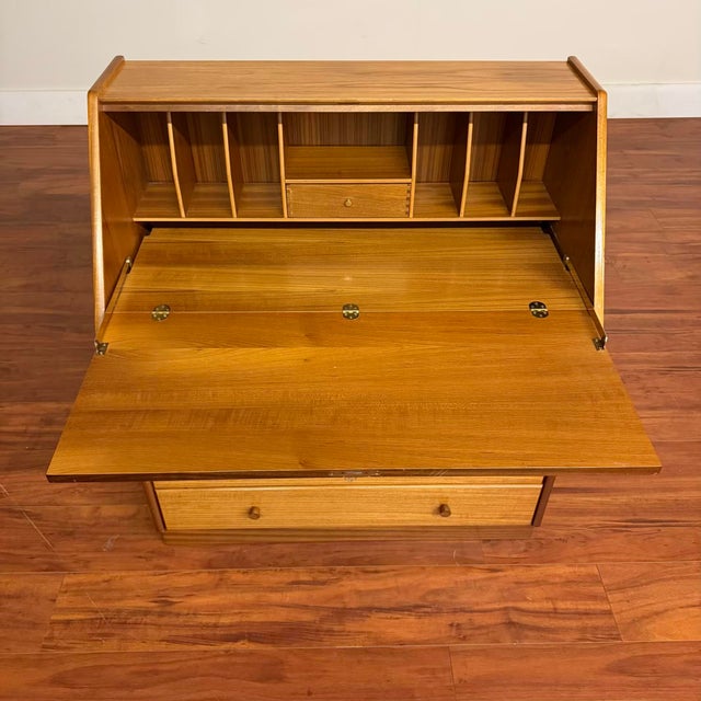 Nathan Furniture vintage teak secretary desk with a drop-down front that becomes the writing surface. Inside the top...