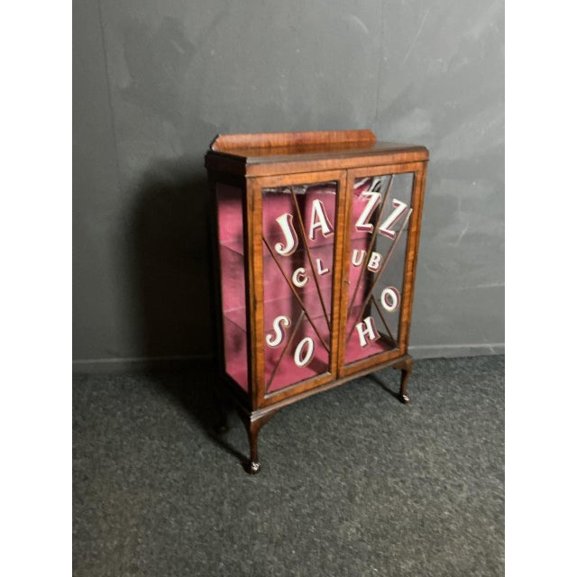 This is an English Walnut cabinet from the 1930’s Art Deco period. The striking Jazz Club writing is a later addition but...