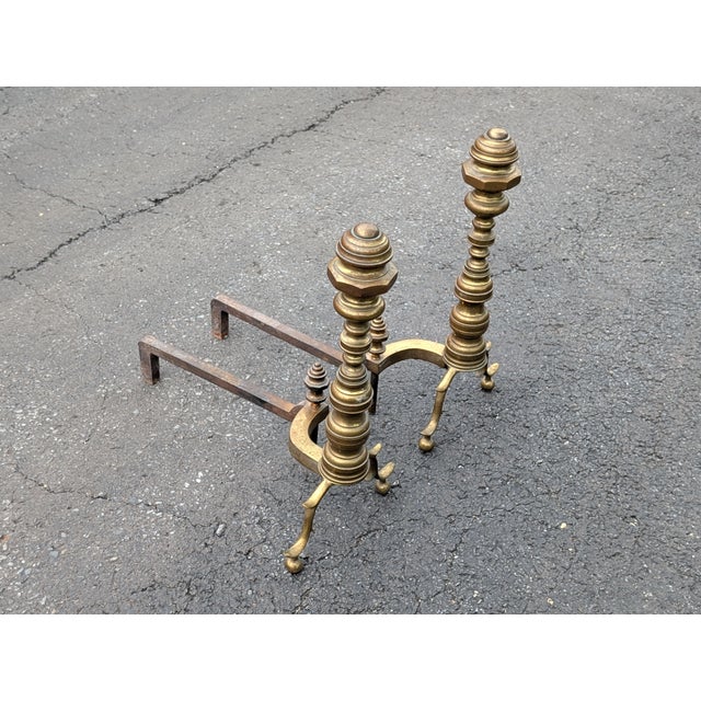 Conveying timeless elegance and substantial craftsmanship, this pair of early 20th-century brass and iron beehive-style...