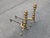 Conveying timeless elegance and substantial craftsmanship, this pair of early 20th-century brass and iron beehive-style...