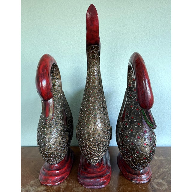 Three beautifully carved wood ducks with mirror inlay and gold accents. Two of the ducks are 20" tall and the largest is...