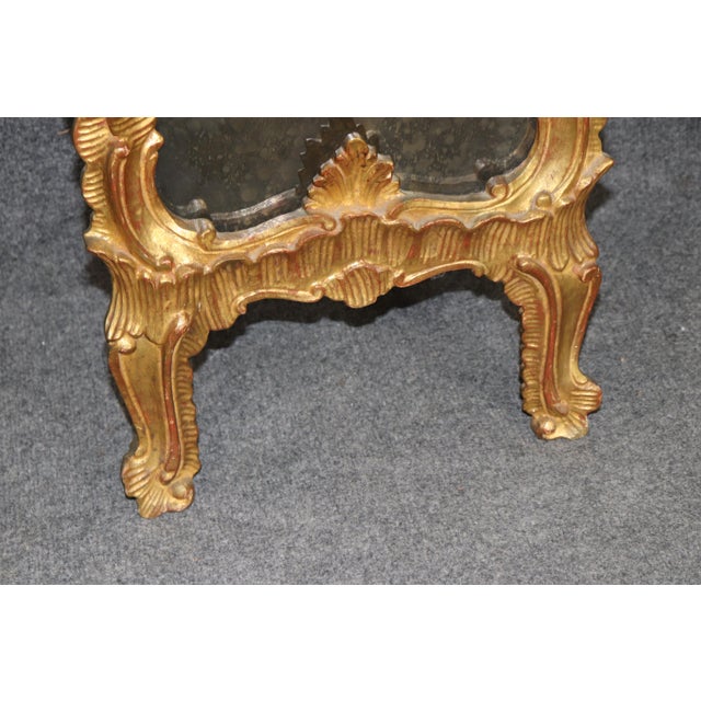 This magnificent pair of monumental Rococo style giltwood mirrors embodies the elegance, movement, and exuberance of...