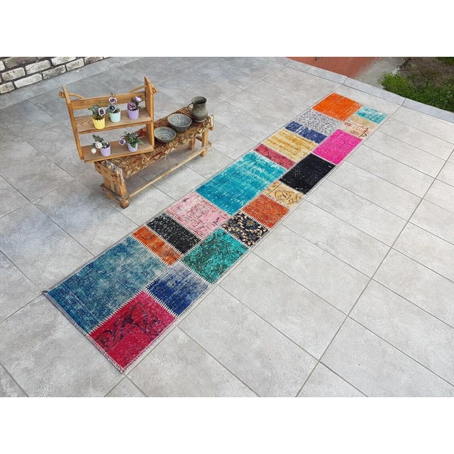 This is a vintage Turkish Oushak rug from the Mid 20th Century. The piece was hand-knotted.