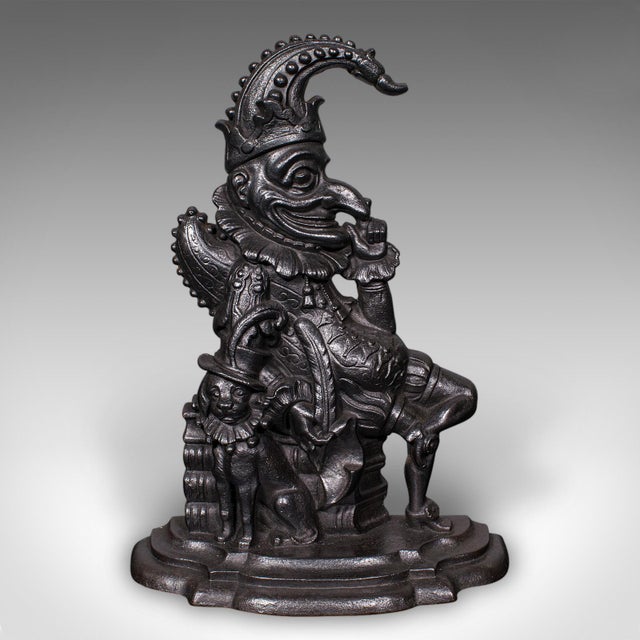 This is a delightful antique Mr Punch doorstop. An English, cast iron figural door keeper, dating to the Victorian period,...