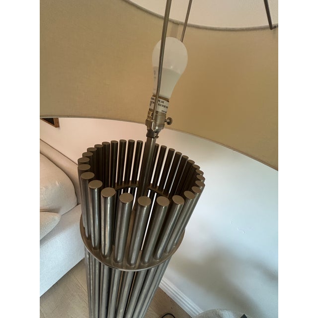Pair of Slim Chrome Column Floor Lamps. The base is a hollow combination of tubular chrome finished rods that is connected...