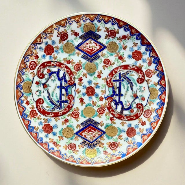 This Japanese Imari porcelain wall plate is an example of classic Arita ware, celebrated for its rich palette of cobalt...
