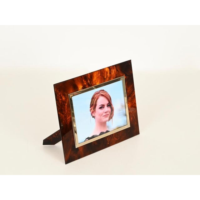 Stunning Mid-Century rectangular photo frame entirely crafted in vibrant tortoiseshell-effect acrylic and gilt brass. This...