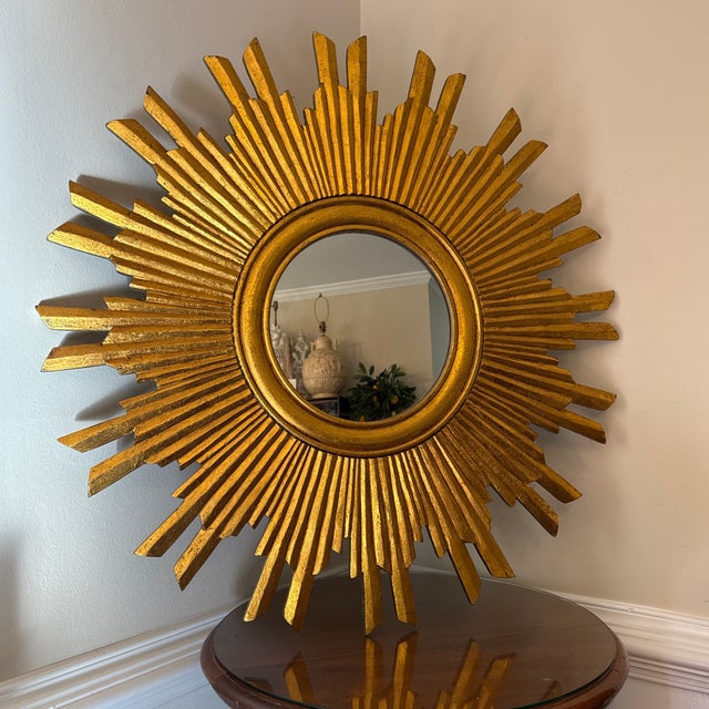 Make a striking statement in any room with this brilliant vintage sunburst wall mirror. Featuring a rich, textured...