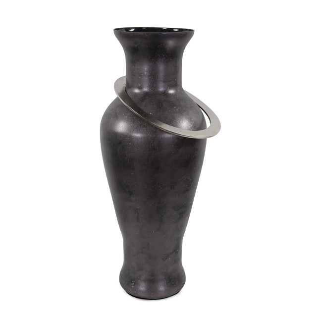 The black ore vases derive their name from a recent trip to a stone quarry. After watching massive sections of dark black...