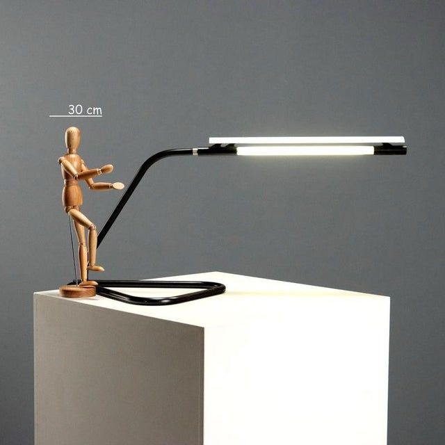 The 'Tubino' table lamp, designed by brothers Achille and Pier Giacomo Castiglioni for Flos in the 1960s and 1970s, is an...