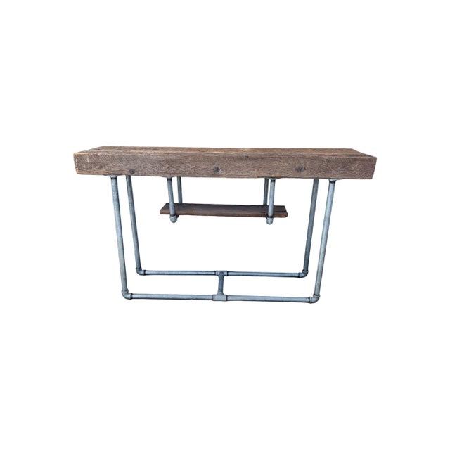 Industrial foyer console table from the 1950's-60's . It features construction of iron pipes and solid thick wooden plank....