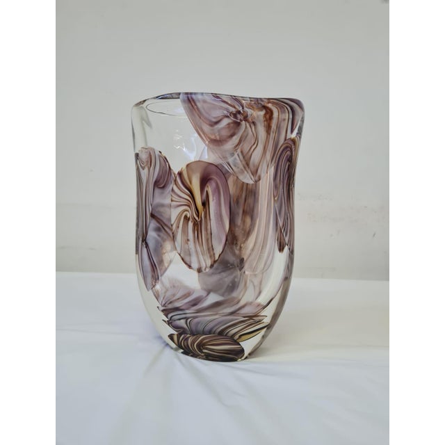 DUTIES FREE (This item is not always available,) A refined example of Italian glass artistry, this sculptural Murano vase...