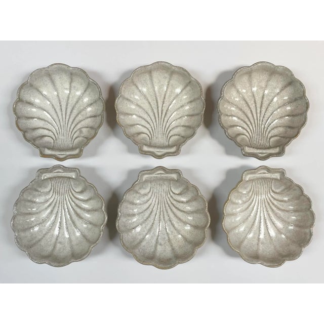 This set of 6 shell shaped pottery shallow bowls, glazed in a palette of off-white, light gray and beige, are perfect for...