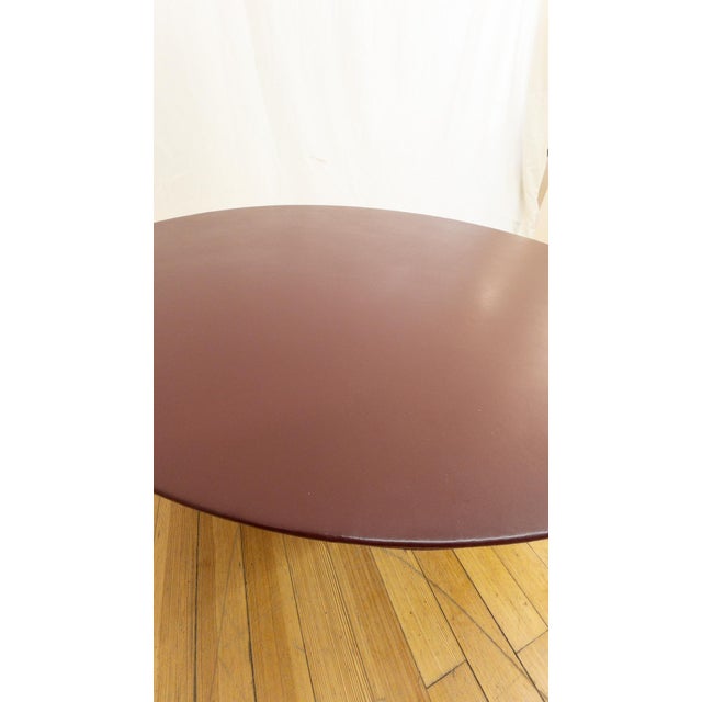 Bocci coffee table featuring a burgundy leather top and silver ball base. Sculptural design with a distinctive rounded...