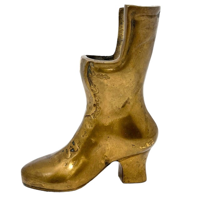 Add a touch of brass to your decor with this vintage Victorian style ladies brass boot from the 1970s. This brass boot was...