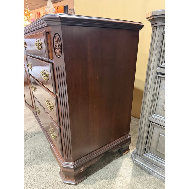 Timeless craftsmanship meets classic American design in this elegant Ethan Allen cherry wood dresser, a beautifully...