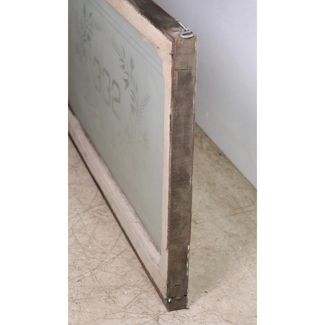 Rectangular frosted glass window with house number 332 in the center surrounded by foliate detail. The pine frame is...