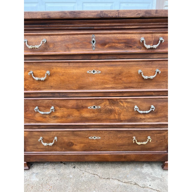 Crafted in solid walnut during the 19th century, this elegant French Louis Philippe commode features a clean, timeless...