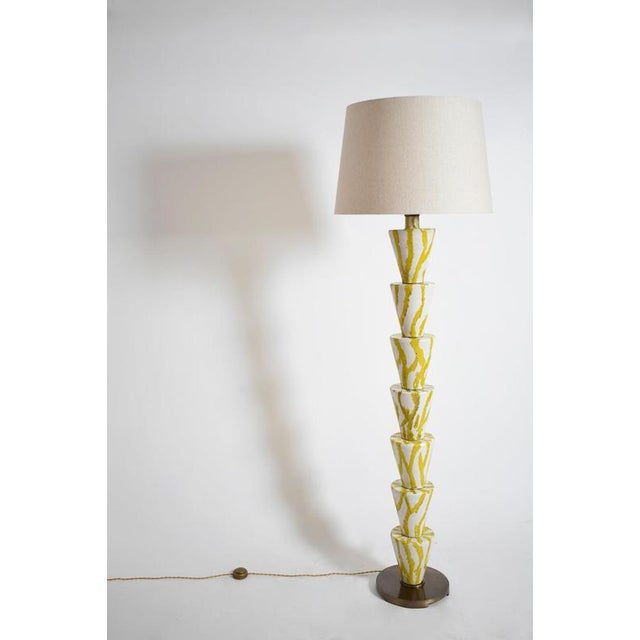 “Nizwa” white and yellow floor lamp, Barracuda edition. "Nizwa" stoneware glazed floor lamp in white and yellow, on a...