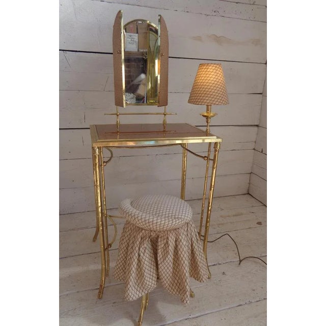 Beautiful dressing table with built-in lamp and matching seat. The metal structure in the shape of slender bamboo stems...