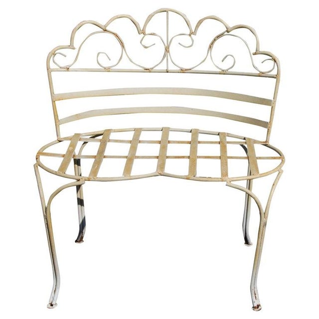 Victorian-Style Wrought Iron Curved Garden Bench Charming petite wrought iron garden bench with an open and airy design...