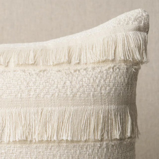 This pillow features Acadia with a knife edge finish. A horizontal fringed stripe, this pattern derives from a textile in...